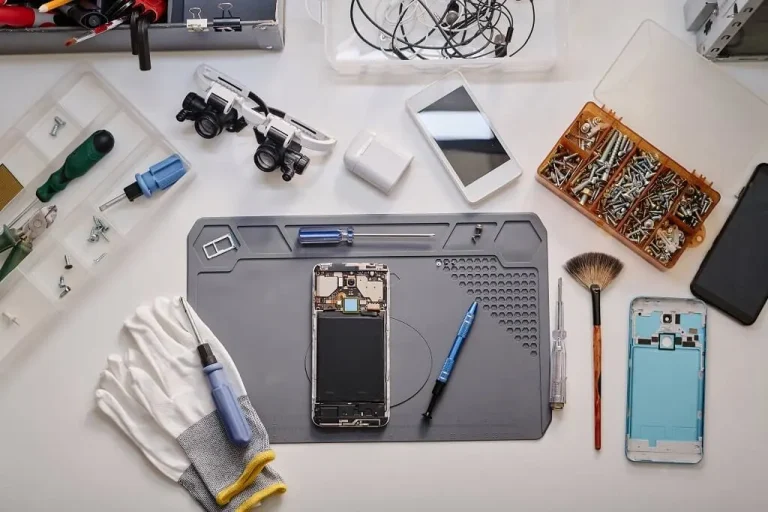 Smartphone repair workbench with tools and phone parts for professional mobile device servicing and maintenance